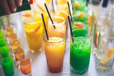 Farklı renkli alkol kokteyller bir parti, martini, votka ve diğer açık hava olay, resim ile güzel bir şekilde dekore edilmiş catering buket masaya güzel satır satır