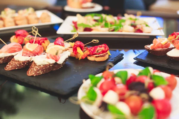 Güzel dekore edilmiş yemek sofrası farklı yemek ve aperatiflerle kurumsal noel partisi ya da düğün kutlaması için. — Stok fotoğraf