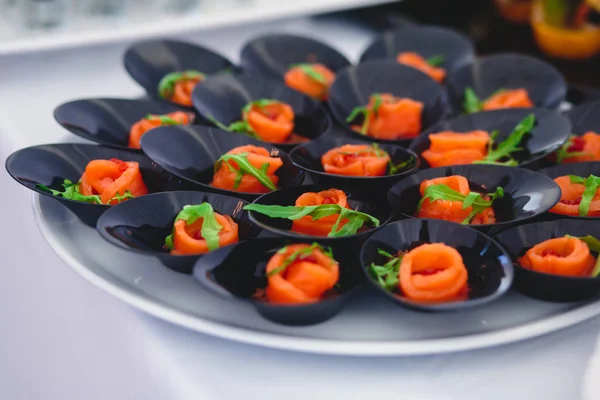 Beautifully luxury decorated catering banquet table with black and red caviar and different food snacks on a corporate christmas birthday party event or wedding celebration — Stock Photo, Image