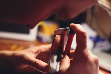 Sökmeye yakın çekim süreci ve kırık kırık ekran cam ve evde ayrıntıları değiştirme ile modern cep telefonu akıllı telefon ortadan kaldırmak