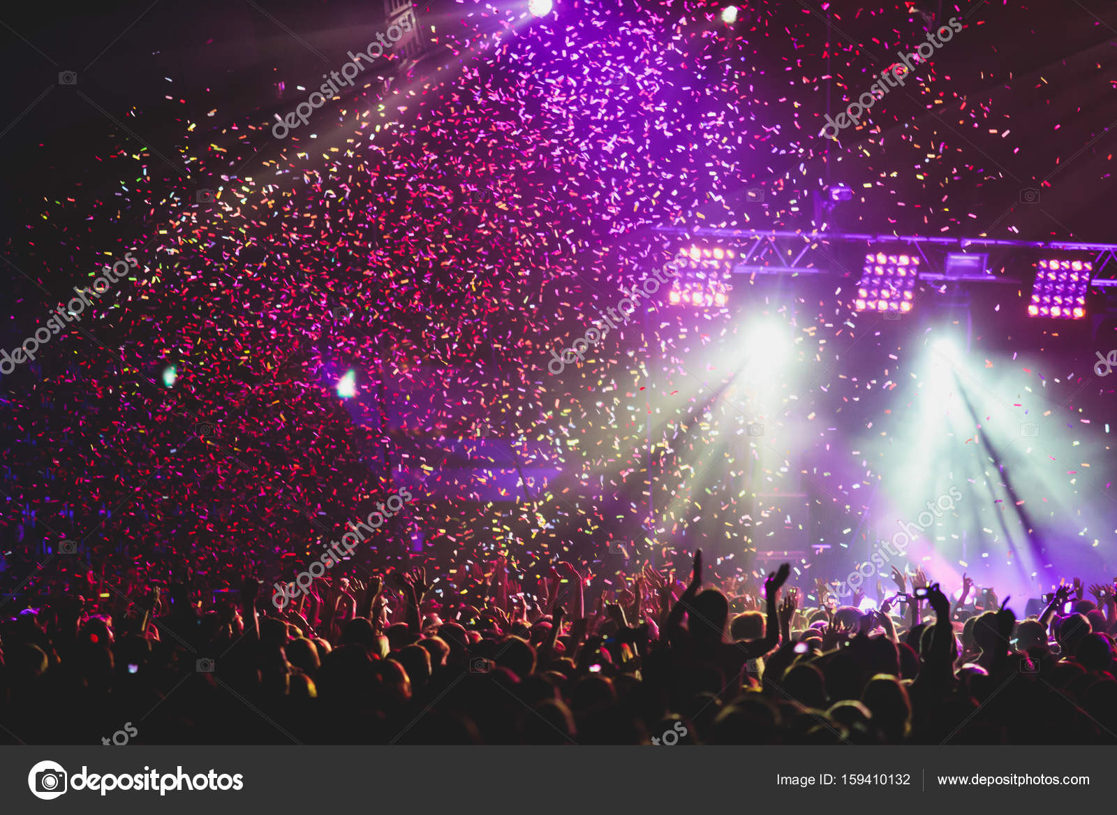 View of rock concert show in big concert hall, with crowd and stage