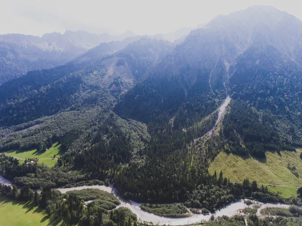 View of bavarian alpine village with a valley and mountains, shot from drone, Bayern, Bavaria, Germany, sunny summer day — Stock Photo, Image