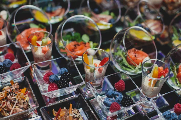 Beautifully decorated catering banquet table with different food snacks and appetizers on corporate christmas birthday party event or wedding celebration, different vegan vegetarian snacks — 스톡 사진