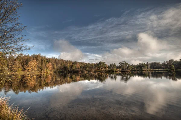 Stunning landscape image of Tarn Hows in Lake District during beautiful Autumn Fall. — Stock Image Stunning landscape image of Tarn Hows in Lake District during beautiful Autumn Fall. Stock Picture