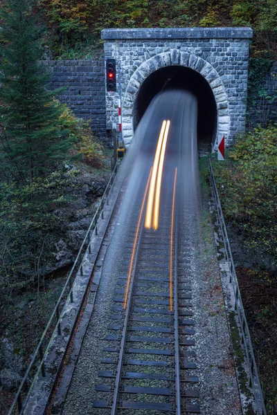 Ancien tunnel en brique dans les montagnes et le train entrant — Photo