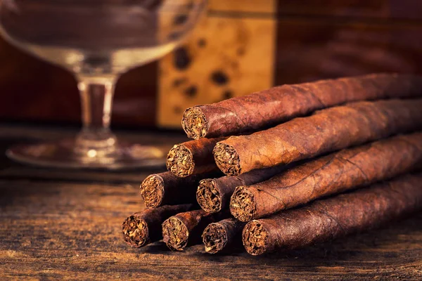 Quality cigars on an old wooden table — Stock Photo, Image