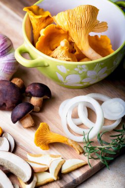 Sliced boletus with chanterelle and onion. Cooking musrooms