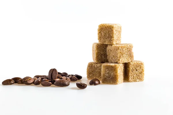 Sugar cubes and coffee bean — Stock Photo, Image