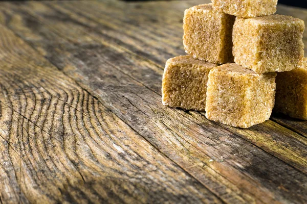 Cane sugar on a old wooden table — Stock Photo, Image