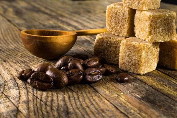 Coffee beans with cane sugar — Stock Photo, Image