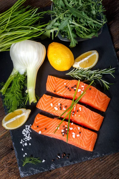 Salmon filet sliced on three parts with lime and herbs. — Stock Photo, Image