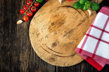 Tahtada sebzeler, otlar ve taş öğütücü var.