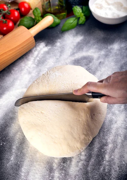 Prepering and cutting pizza dough with knife — 스톡 사진
