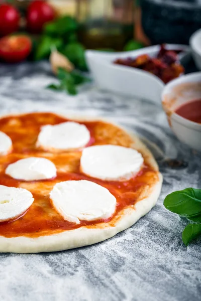 Prepering margherita pizza with mozzarella for baking — 스톡 사진
