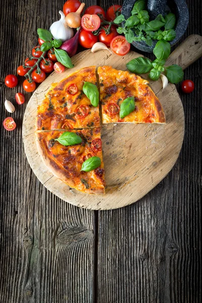 Mozzarella, fesleğen ve domatesli ev yapımı pizza margherita.