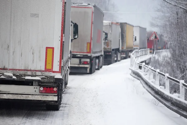 traffic jam of trucks in snowstorm
