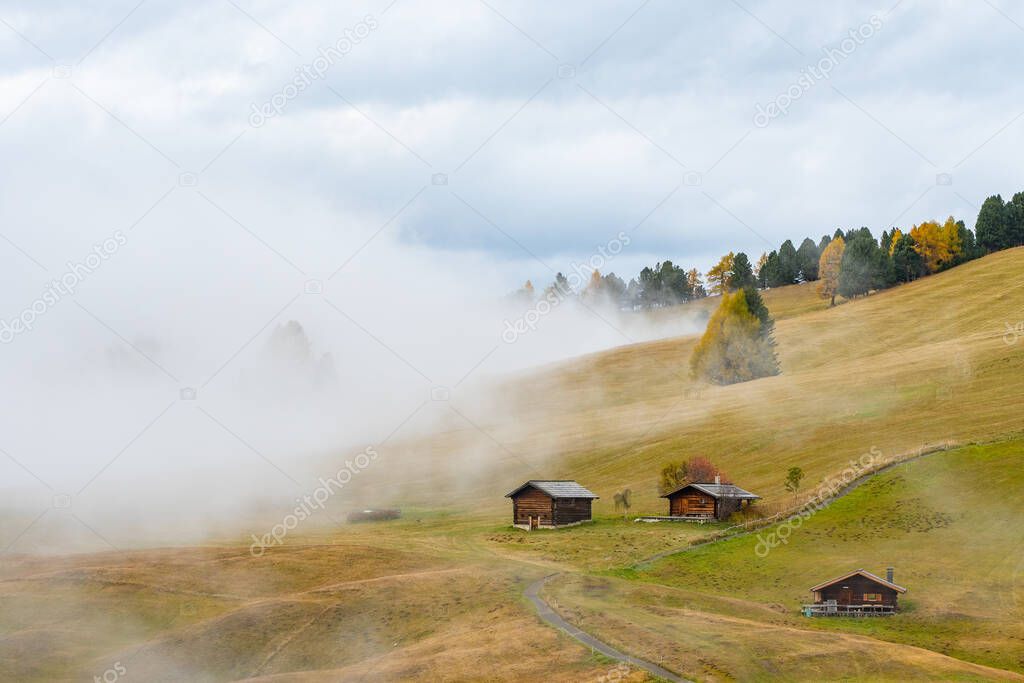 A misty view of the meadows in the Dolomites after the rain