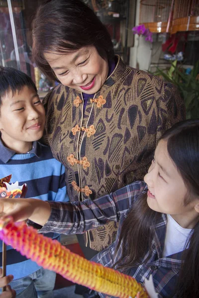 Asian family in front of store — Stock Photo, Image