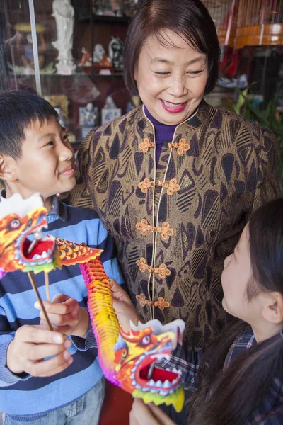 Asian family in front of store — Stock Photo, Image