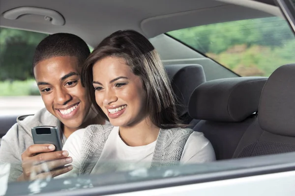 Teenagers using mobile phone in car — Stock Photo, Image