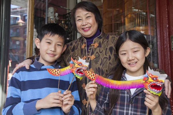 Asian family in front of store Royalty Free Stock Photos