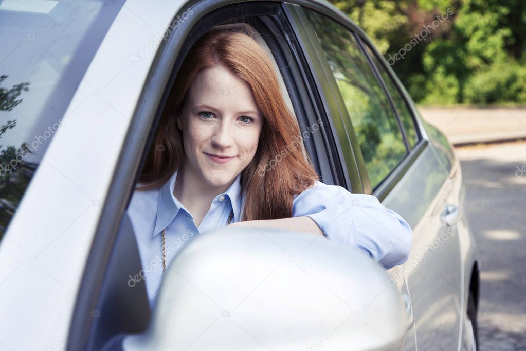 Teenager girl sitting in car