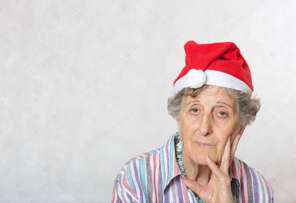 Old woman in the hat of a santa claus