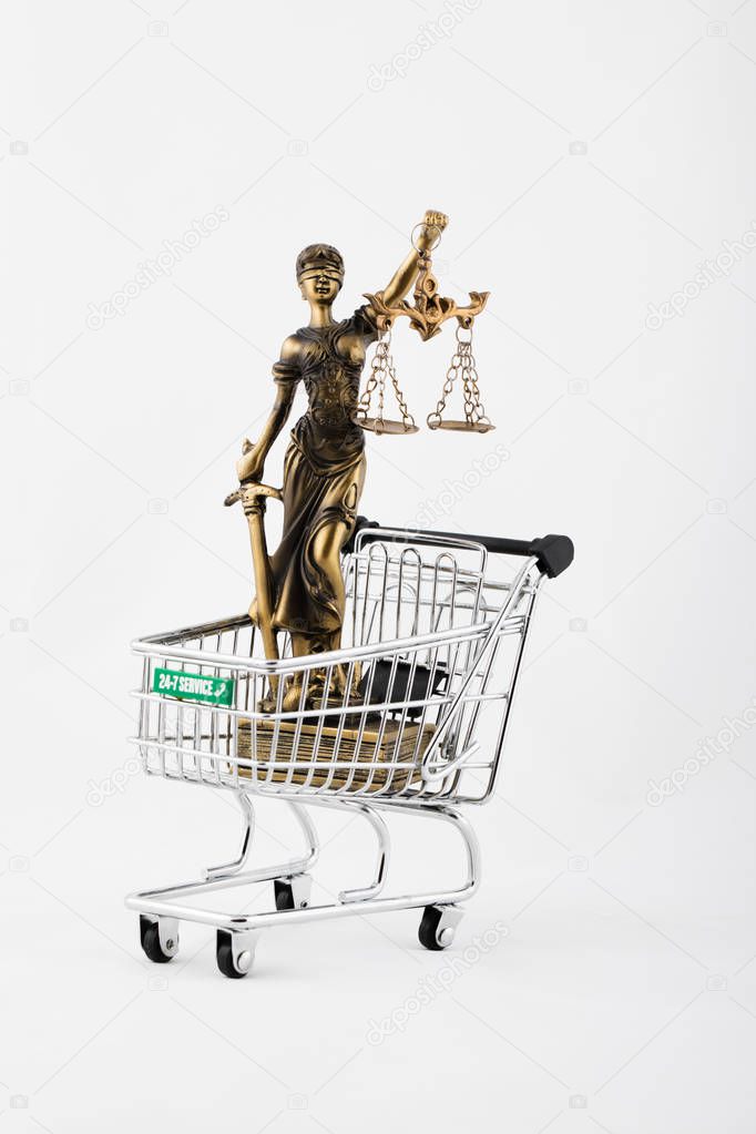 Statue of Themis in a mini shopping cart. 