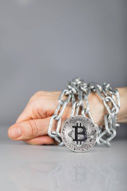 Bitcoin görüntüleyin. Metalik zinciri içinde belgili tanımlık geçmiş bağlı el.