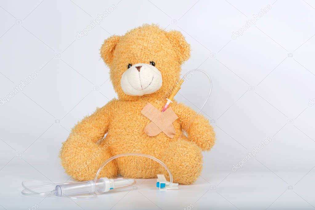 Teddy bear with blood transfusion system. Closeup