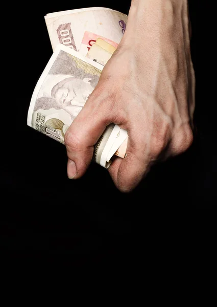 Dłoni chłopka z stare banknoty na czarnej tkaniny. CL — Zdjęcie stockowe
