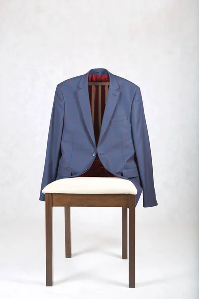 Male classical jacket is hanging on a chair. — Stock Photo, Image