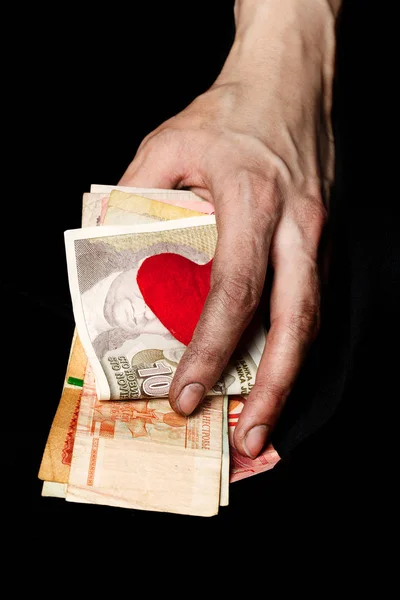 Palm of a peasant woman with old banknotes on a black fabric. Cl — Stock Photo, Image