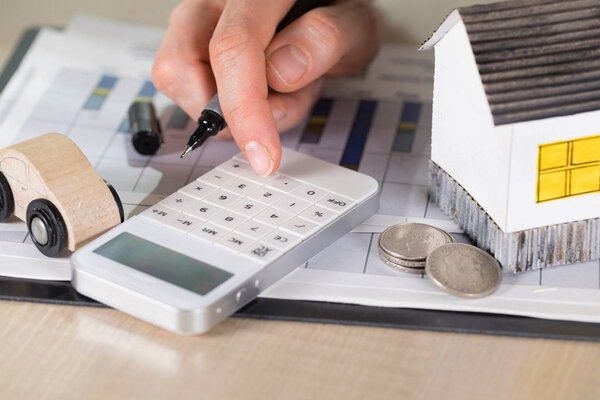 White calculator on statistical diagram. Closeup.