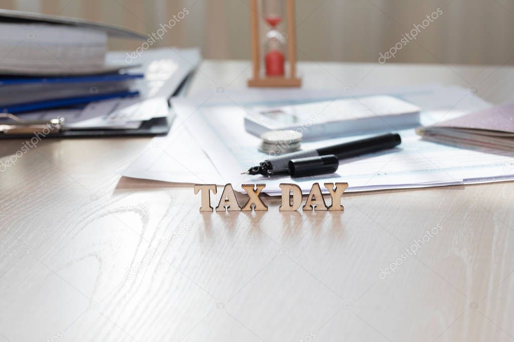 Word TAX DAY composed of wooden letters. Closeup