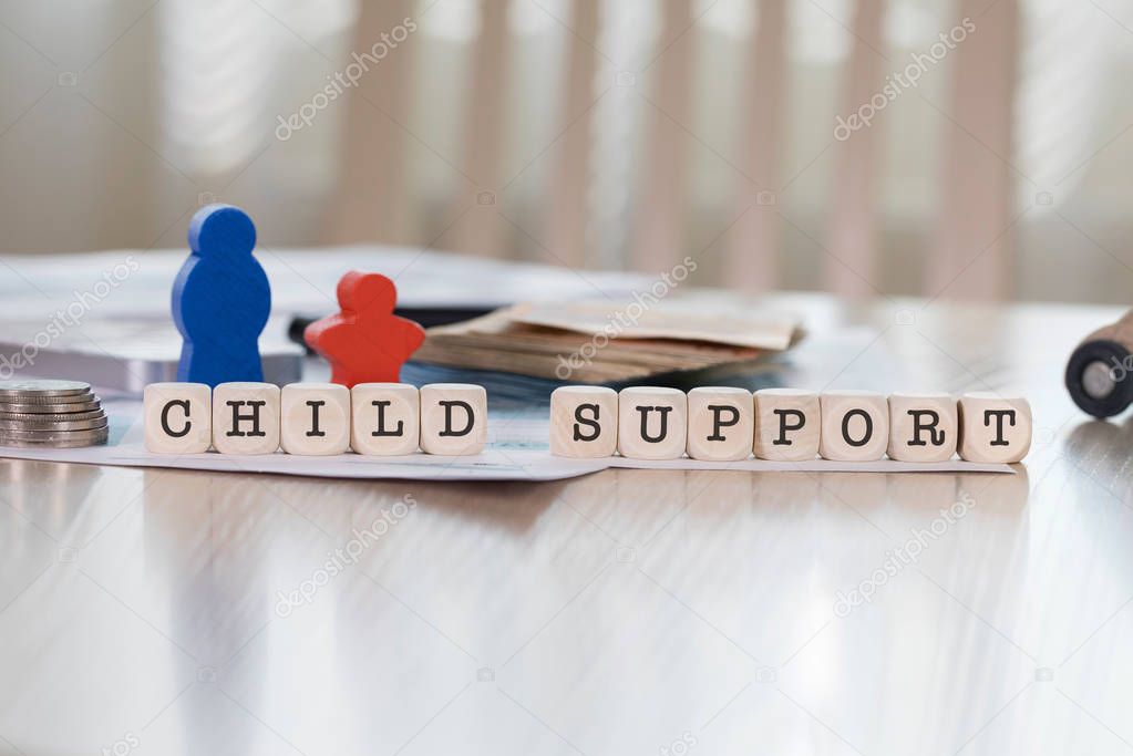 Word CHILD SUPPORT composed of wooden letters. Closeup
