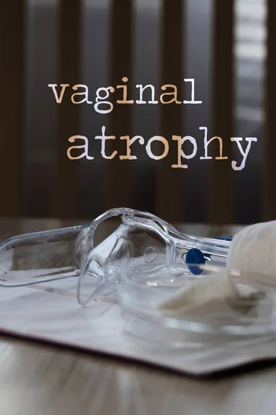 Words VAGINAL ATROPHY. Plastic vaginal speculum, pills and other — Stock Photo, Image