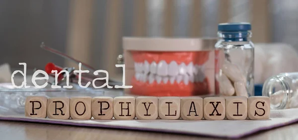 Words DENTAL PROPHYLAXIS composed of wooden dices. Pills, docume — Stock Photo, Image
