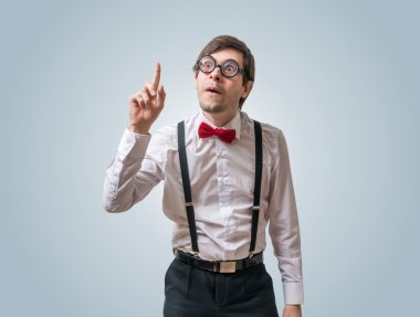 Funny nerd or geek have an idea and holds finger up. clipart