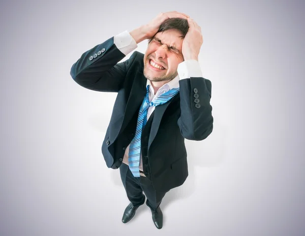Disappointed businessman holds his head. View from top. — Stock Photo, Image