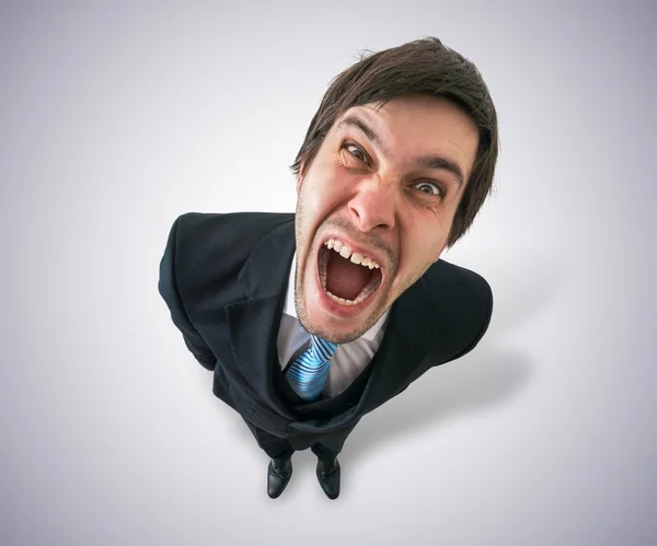 Young crazy businessman or boss is screaming. View from top. — Stock Photo, Image