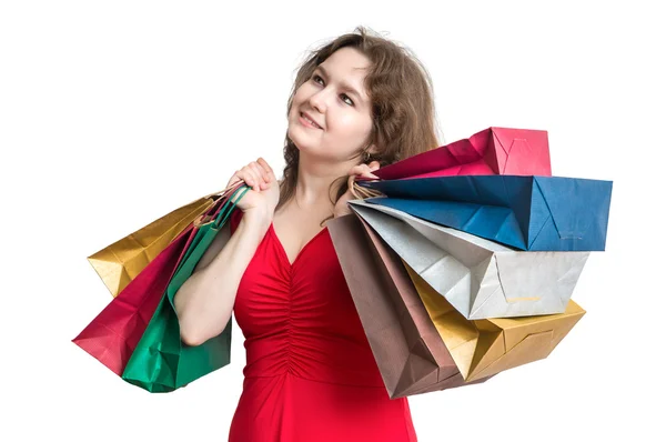 Молодая женщина ходит по магазинам и держит много мешков в руках. Изолированный на белом фоне . — стоковое фото