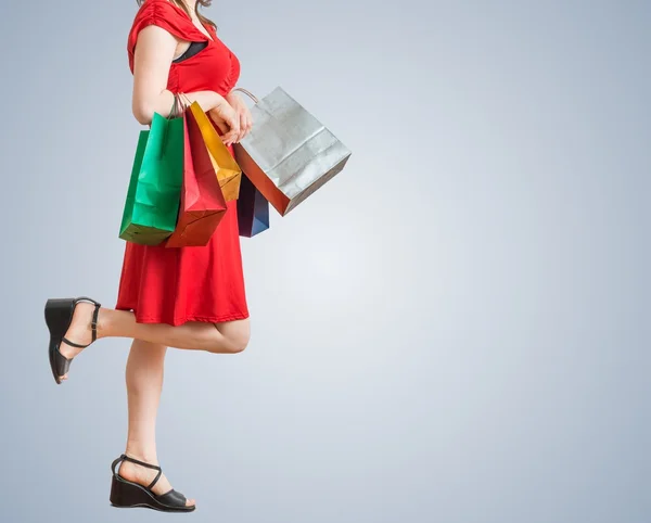 Молодая красивая женщина ходит по магазинам с красочными сумками . — стоковое фото