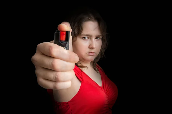 Young woman is defending with pepper spray. Self defense concept. Low key photo. — Stock Photo, Image