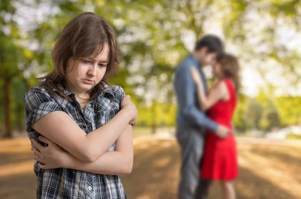 Young jealousy girl is seeing her boyfriend with other one girl. — Stock Photo, Image