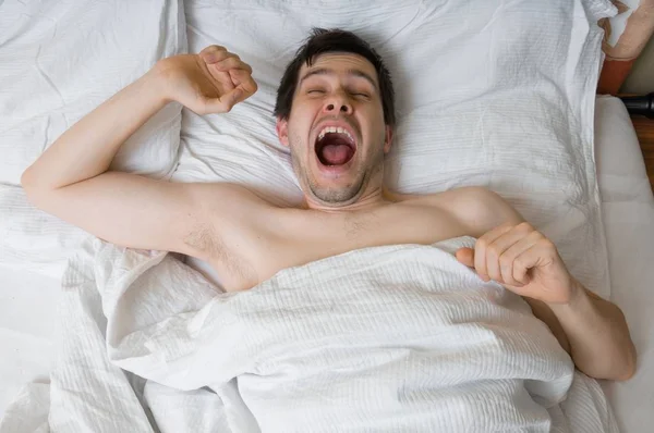 Young man is waking up in morning. — Stock Photo, Image