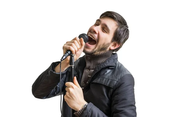 Concepto de karaoke. El joven sostiene micrófono y canta canción. Aislado sobre fondo blanco . — Foto de Stock