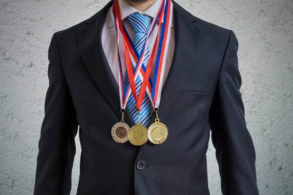 Awarded businessman is wearing many medals.