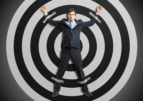 Businessman is taped to the target with adhesive tape. — Stock Photo, Image