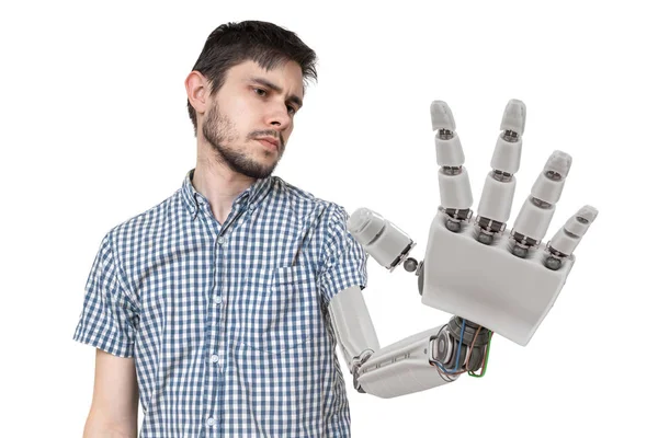 Young is looking at his robotic hand. Isolated on white background. 3D rendered illustration of hand. — Stock Photo, Image